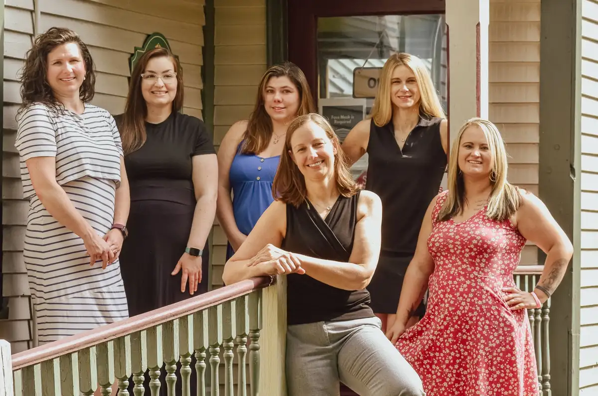 Six members of the South Royalton Health Center team together on the porch of the practice